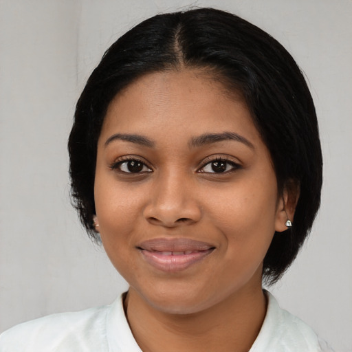 Joyful latino young-adult female with medium  black hair and brown eyes
