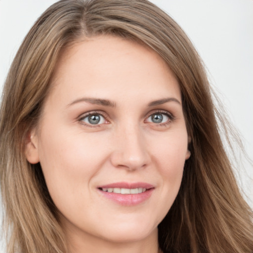 Joyful white young-adult female with long  brown hair and grey eyes