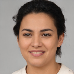 Joyful latino young-adult female with short  brown hair and brown eyes