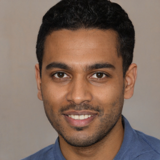 Joyful black young-adult male with short  black hair and brown eyes
