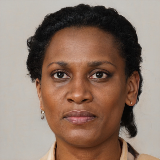 Joyful black adult female with short  brown hair and brown eyes