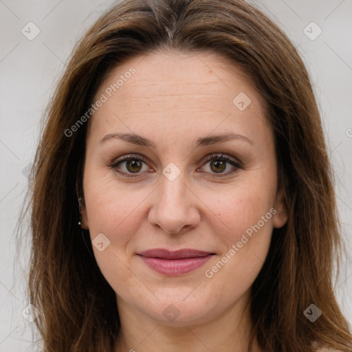 Joyful white adult female with long  brown hair and brown eyes