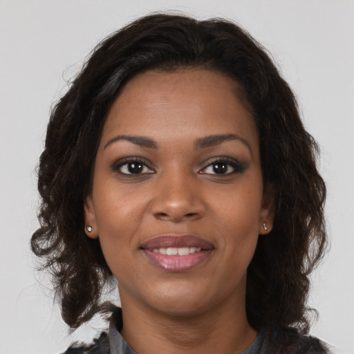 Joyful black young-adult female with medium  brown hair and brown eyes