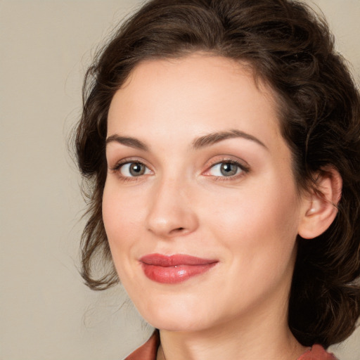 Joyful white young-adult female with medium  brown hair and green eyes