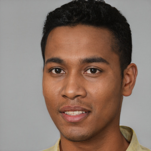 Joyful black young-adult male with short  black hair and brown eyes