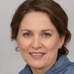 Joyful white adult female with medium  brown hair and grey eyes