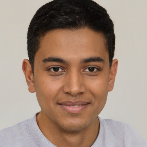Joyful latino young-adult male with short  brown hair and brown eyes