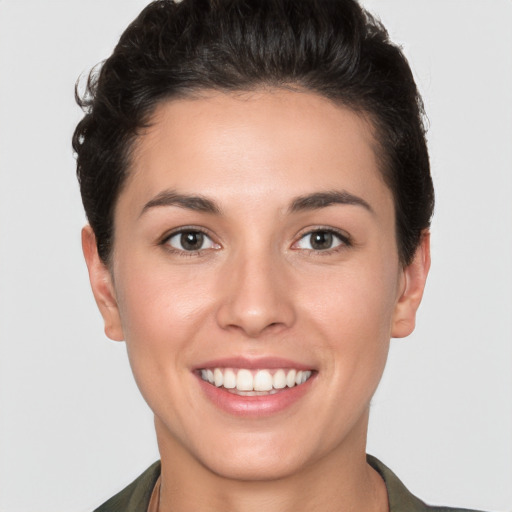 Joyful white young-adult female with short  brown hair and brown eyes