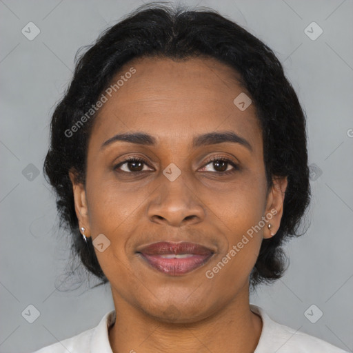 Joyful black adult female with medium  brown hair and brown eyes