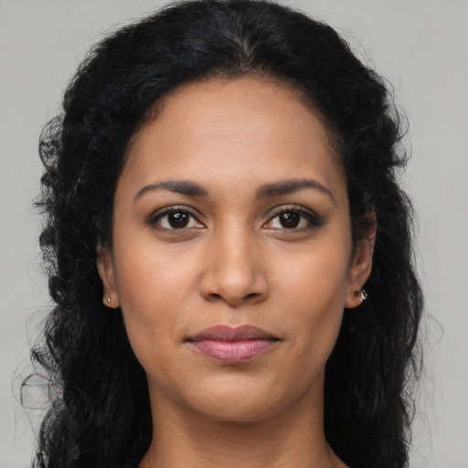 Joyful latino young-adult female with long  brown hair and brown eyes