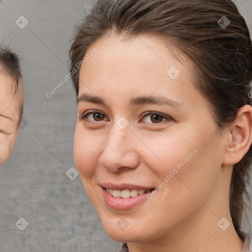 Joyful white young-adult female with medium  brown hair and brown eyes