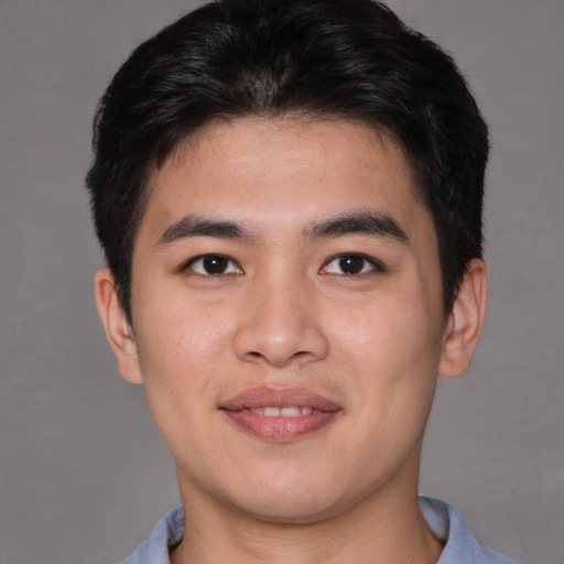 Joyful asian young-adult male with short  brown hair and brown eyes