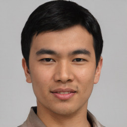 Joyful asian young-adult male with short  black hair and brown eyes