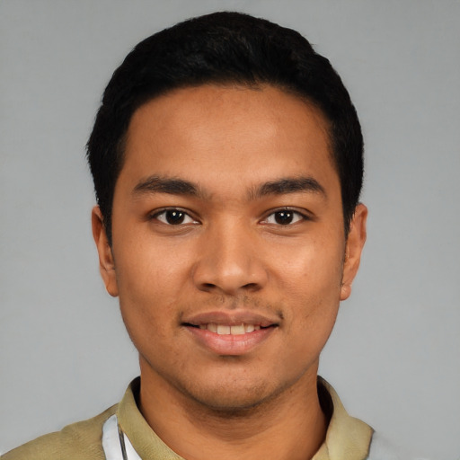 Joyful latino young-adult male with short  black hair and brown eyes