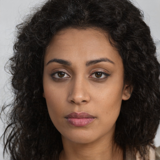 Joyful latino young-adult female with long  brown hair and brown eyes