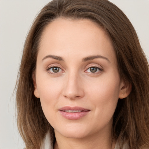 Joyful white young-adult female with long  brown hair and grey eyes