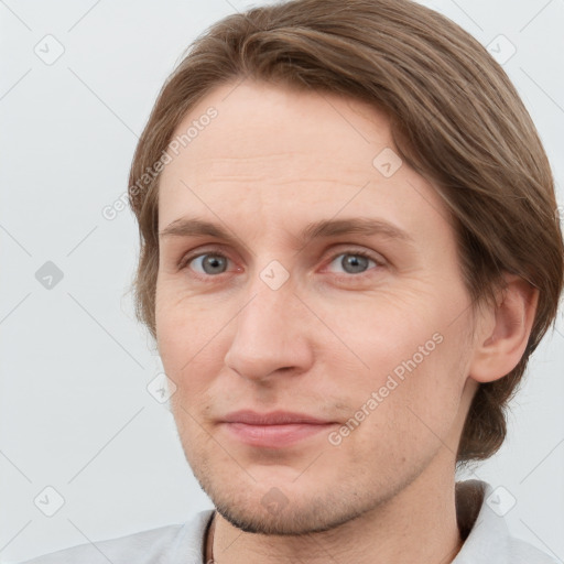 Joyful white adult male with short  brown hair and grey eyes