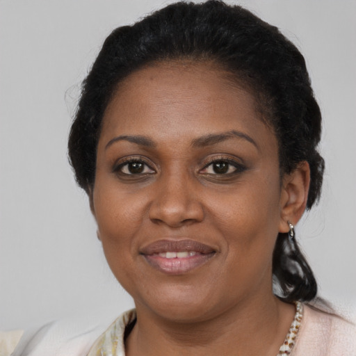 Joyful black adult female with medium  black hair and brown eyes