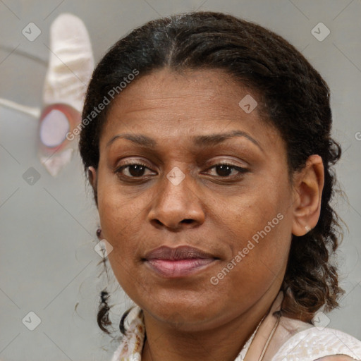 Joyful black adult female with medium  brown hair and brown eyes