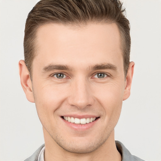 Joyful white young-adult male with short  brown hair and brown eyes