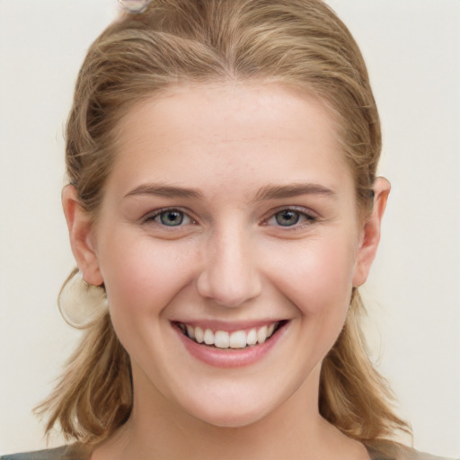 Joyful white young-adult female with long  brown hair and blue eyes