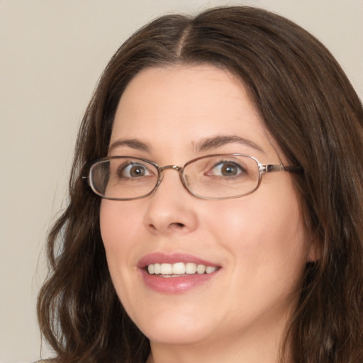 Joyful white adult female with medium  brown hair and green eyes