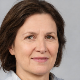 Joyful white adult female with medium  brown hair and brown eyes