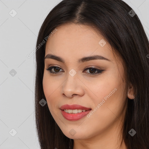 Joyful asian young-adult female with long  brown hair and brown eyes