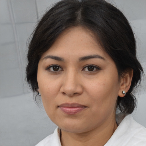 Joyful asian young-adult female with medium  brown hair and brown eyes