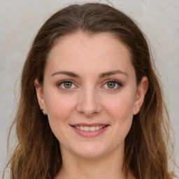 Joyful white young-adult female with long  brown hair and green eyes