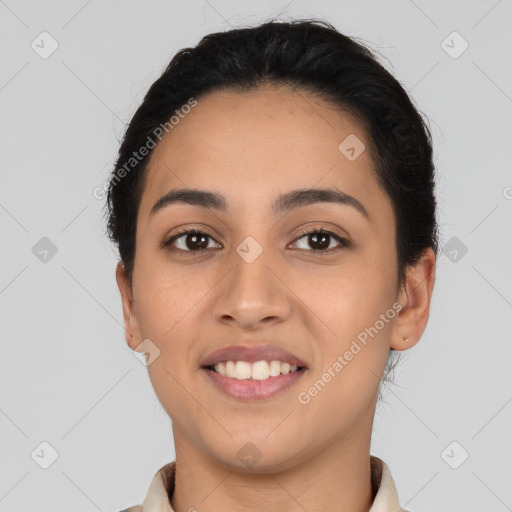 Joyful latino young-adult female with short  black hair and brown eyes