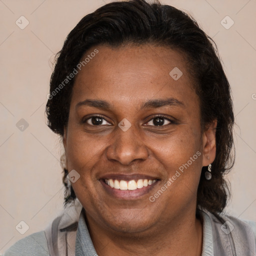 Joyful latino adult female with medium  brown hair and brown eyes