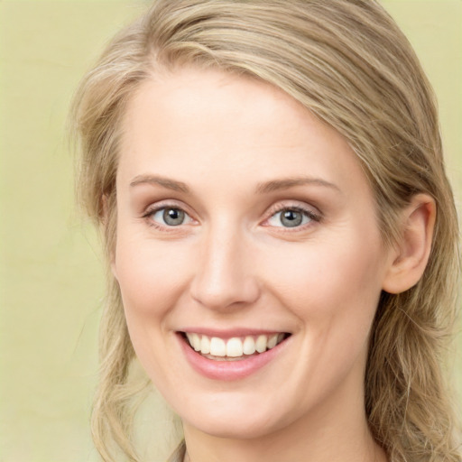 Joyful white young-adult female with long  brown hair and green eyes