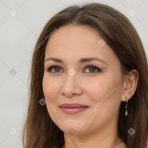 Joyful white adult female with long  brown hair and brown eyes