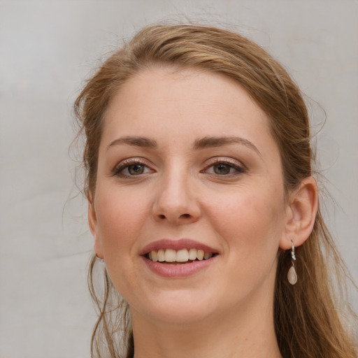 Joyful white young-adult female with long  brown hair and grey eyes