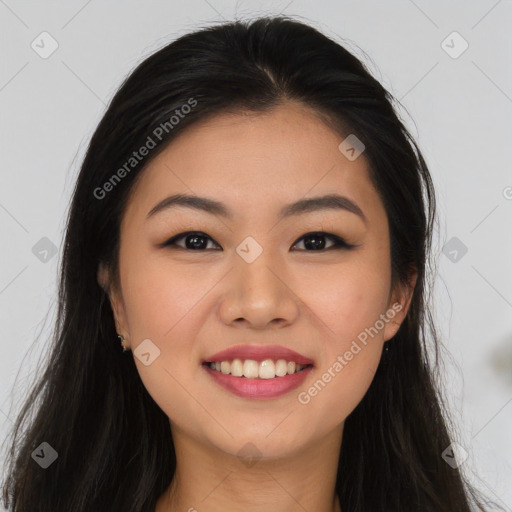 Joyful asian young-adult female with long  brown hair and brown eyes