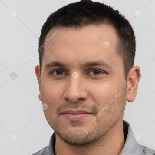 Joyful white young-adult male with short  brown hair and brown eyes