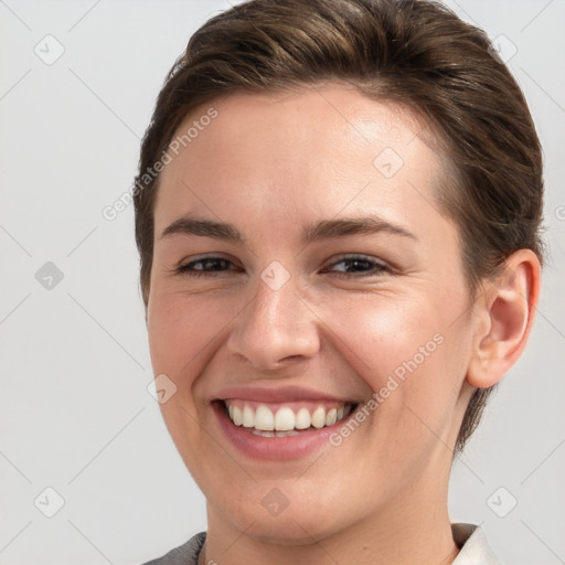 Joyful white young-adult female with short  brown hair and brown eyes