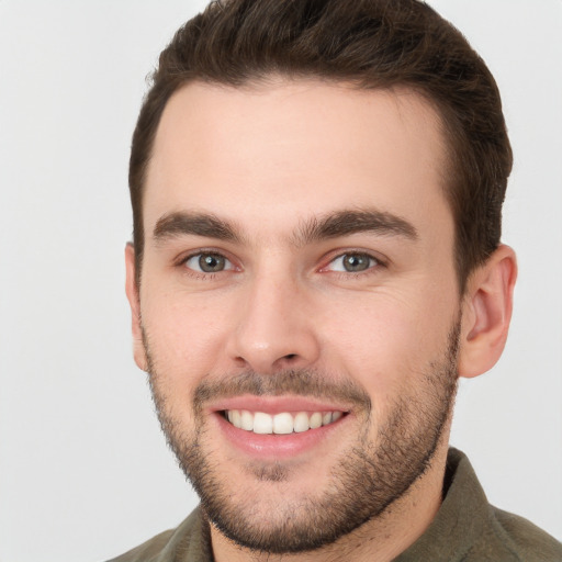 Joyful white young-adult male with short  brown hair and brown eyes