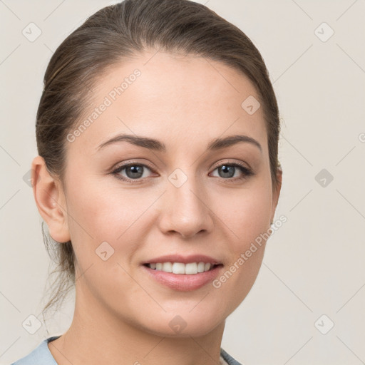 Joyful white young-adult female with medium  brown hair and grey eyes