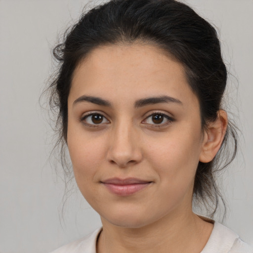 Joyful latino young-adult female with medium  brown hair and brown eyes