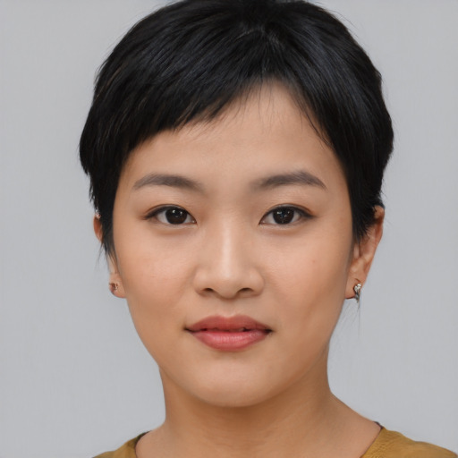 Joyful asian young-adult female with short  black hair and brown eyes