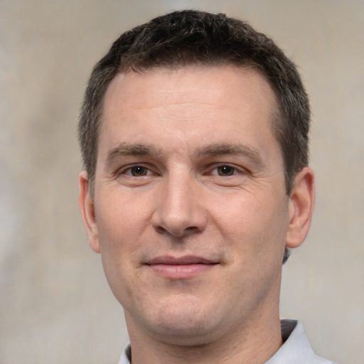 Joyful white adult male with short  brown hair and brown eyes