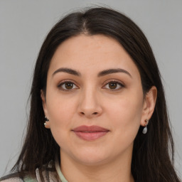 Joyful white young-adult female with long  brown hair and brown eyes