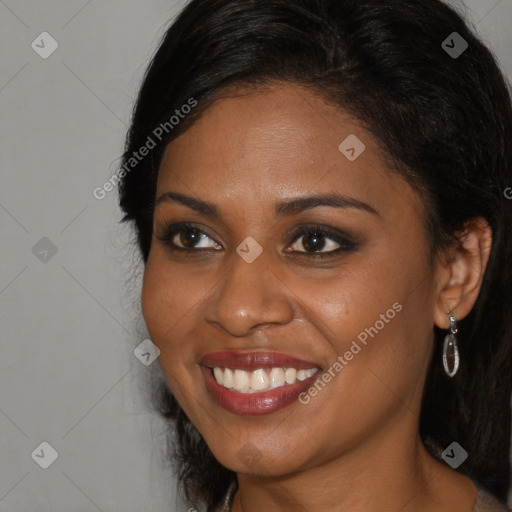 Joyful black young-adult female with long  brown hair and brown eyes