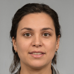 Joyful white young-adult female with medium  brown hair and brown eyes