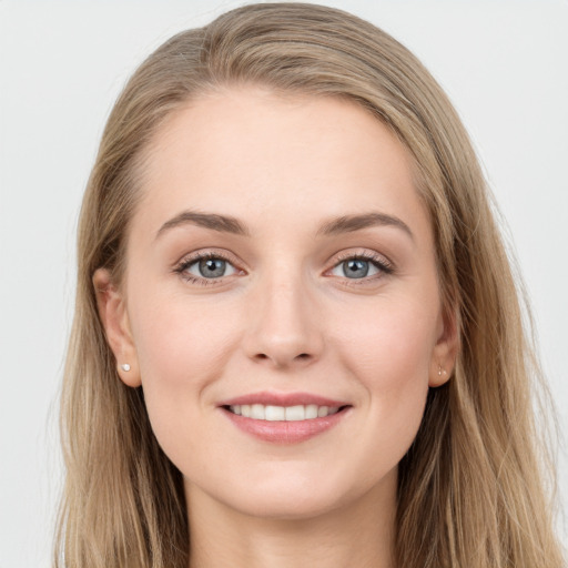 Joyful white young-adult female with long  brown hair and blue eyes