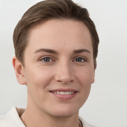 Joyful white young-adult female with short  brown hair and grey eyes