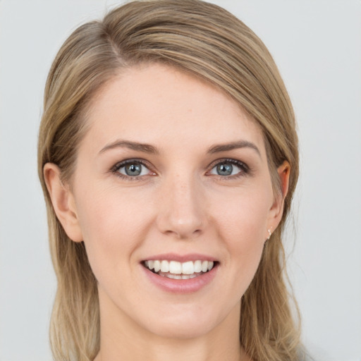 Joyful white young-adult female with long  brown hair and grey eyes