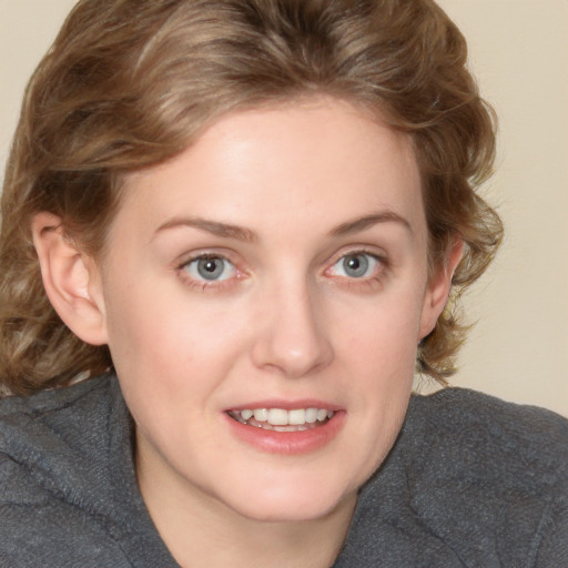 Joyful white young-adult female with medium  brown hair and blue eyes